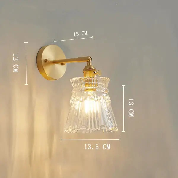 Vintage brass clear glass wall light featuring a ribbed sconce with ornate decorbites clear glass shade for bedroom decor