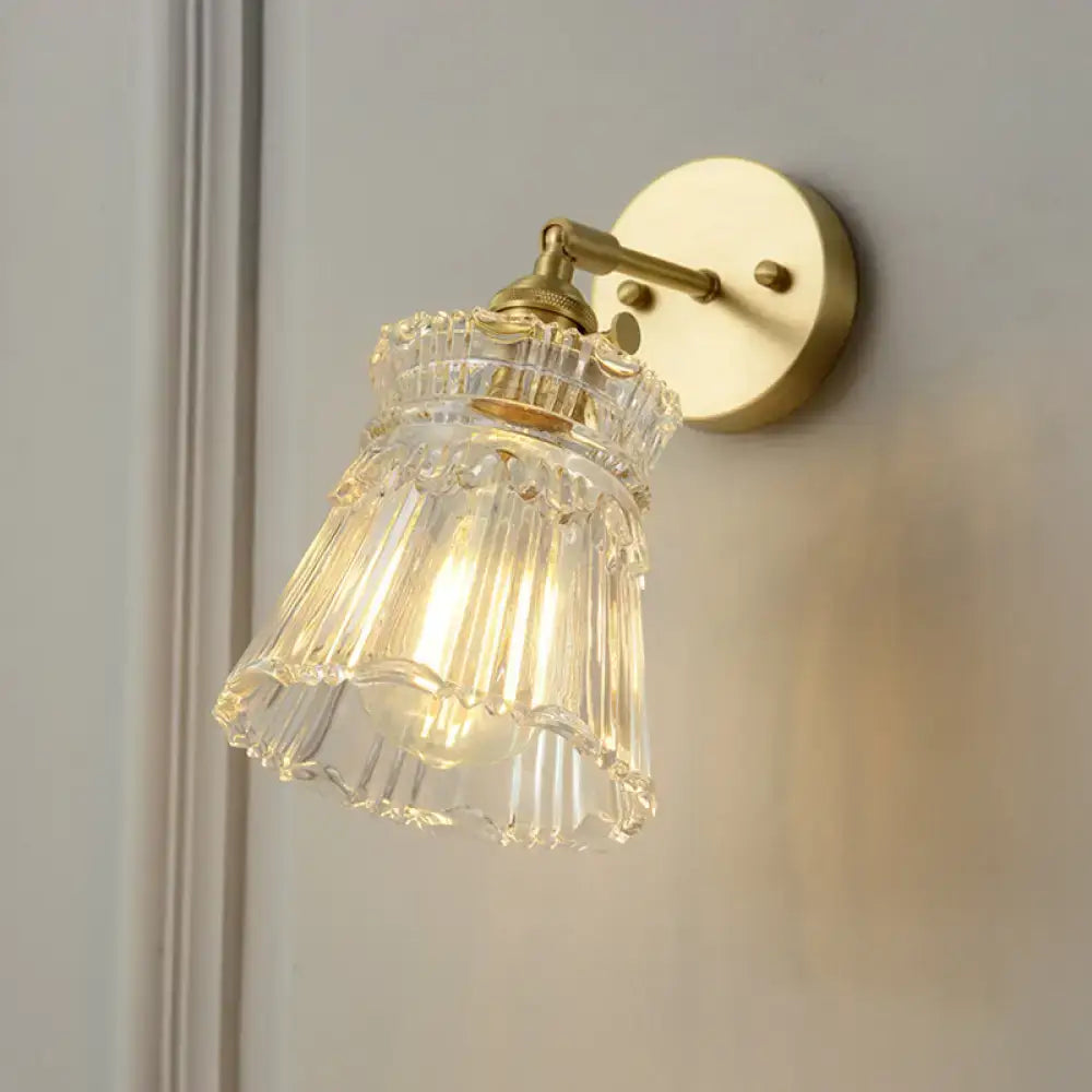 Vintage brass clear ribbed glass wall sconce featuring a fluted glass shade and led incandescent bulb for bedroom lighting