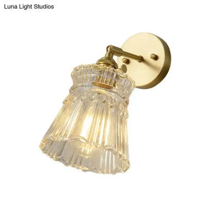 Vintage brass clear ribbed glass wall sconce with ornate design suitable for bedroom led incandescent lighting