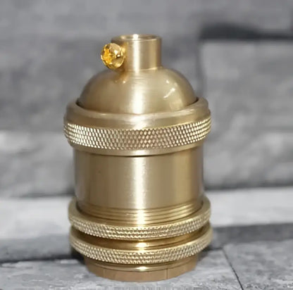 Vintage brass e27 lamp holder with textured ridged bands and golden accent for living room use