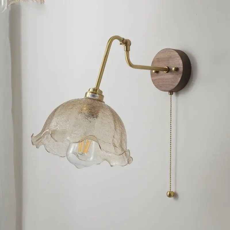 Delicate textured glass lampshade with ruffled edge and brass hardware on vintage brass flower led wall lights with rotate pull chain