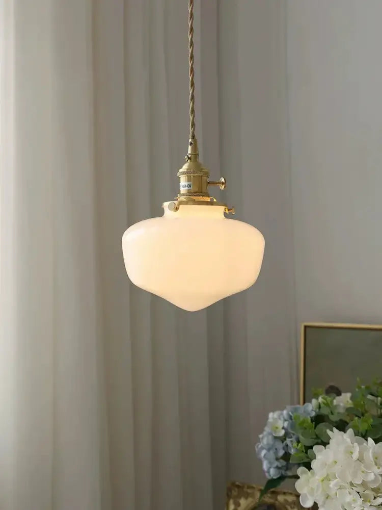 Vintage brass pendant lamp with off-white frosted glass shade led suspended by twisted cord for kitchen use
