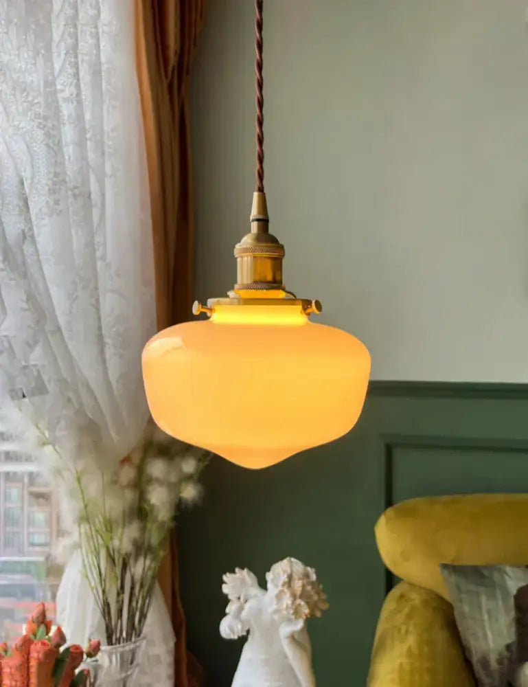 Warm amber glass shade led pendant lamp with brass metal fixture and twisted brown cord for kitchen lighting