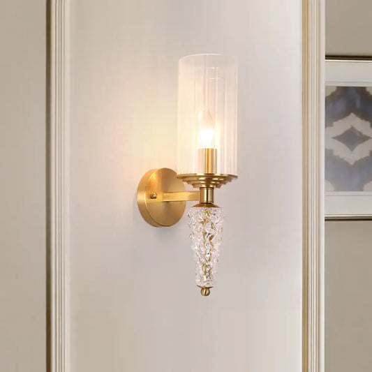 Vintage brass wall mounted lighting fixture with gold-toned glass shade and ornate crystal pendant for bedroom use