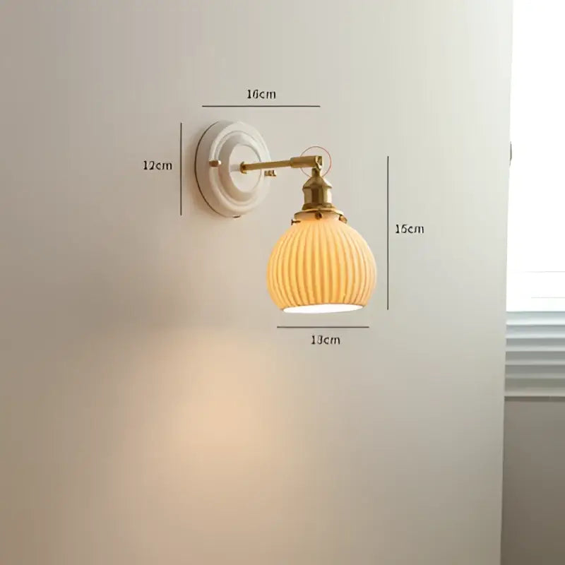 Vintage brass globe wall sconce with cream-colored ribbed glass and brass-finished metal arm for elegant bedroom decorbites copper arm led