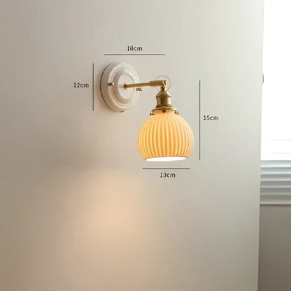 Vintage brass globe wall sconce with cream-colored ribbed glass and brass-finished metal arm for elegant bedroom decorbites copper arm led