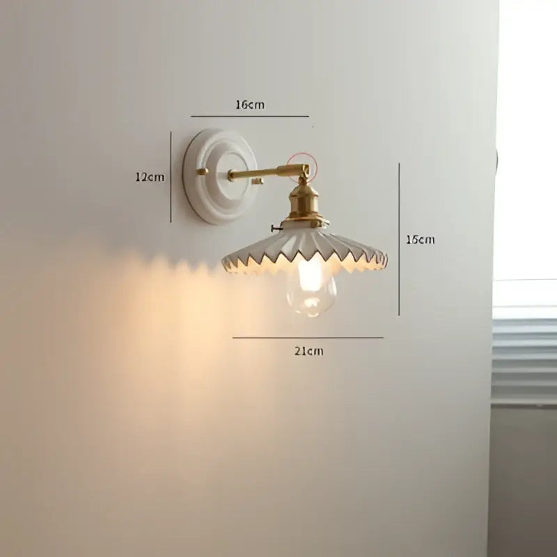Vintage brass globe wall sconce with white ceramic base, brass arm, and scalloped clear ribbed glass shade for decorbites copper arm led lighting