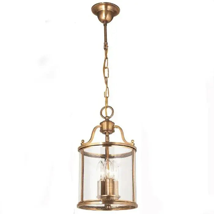Antique brass pendant light with clear glass panels and chain suspension helps create vintage dining room ambiance with led bulbs