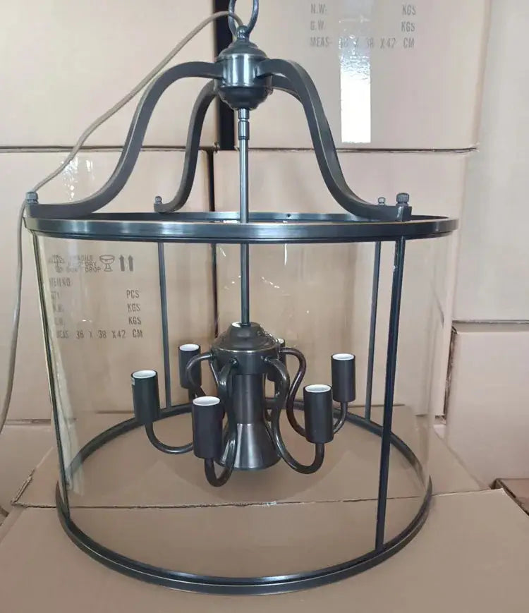 Vintage black metal pendant light with clear glass enclosure and six candle-style led bulbs helps create ambiance