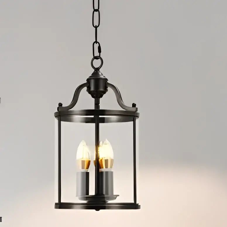 Black wrought iron pendant light with clear glass panels and two lit led bulbs helps create vintage ambiance