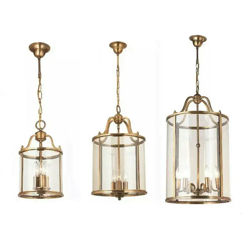 Three elegant vintage brass pendant lights with clear glass enclosures help create warm dining room ambiance with led bulbs