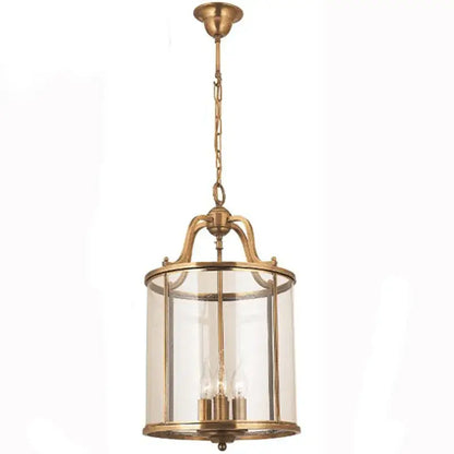 Vintage brass pendant light with clear glass panels and chain suspension helps create a warm dining room ambiance