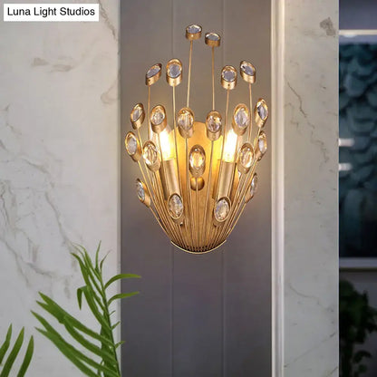 Gold-toned vintage brass wall sconce with peacock tail design featuring clear crystal accents and slender metallic rods