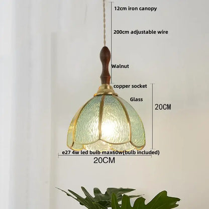 Vintage brass petal glass led pendant light featuring a textured green glass shade with brass accents and walnut canopy