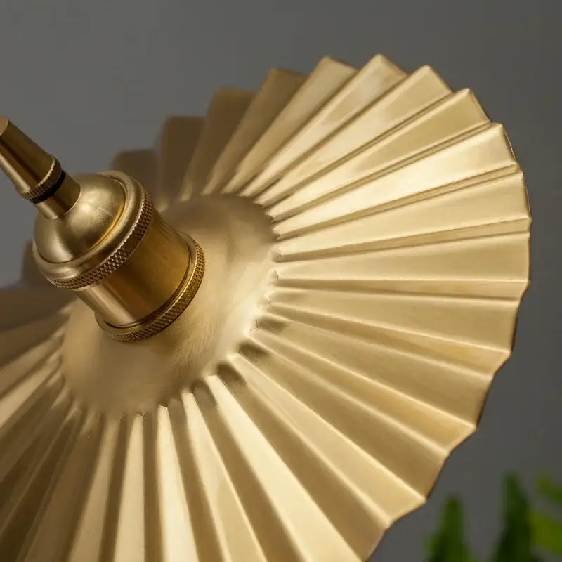 Gold-colored brass pleated led pendant light with textured ridged design for dining room decorbites brass pleated style