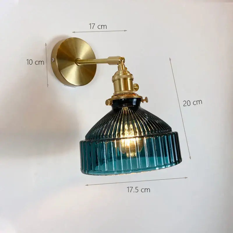 Vintage brass wall sconce with glass shade in ribbed deep teal to light blue tones for bedroom wall lamp use