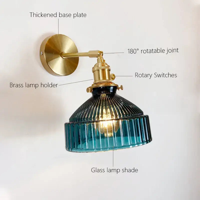 Vintage wall sconce with teal ribbed glass shade and brass-finished metal arm and base for bedroom lighting wall lamp