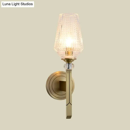 Art deco wall light with brass-finished metal frame, etched glass shade, and crystal accent bead inches fixture for bedroom