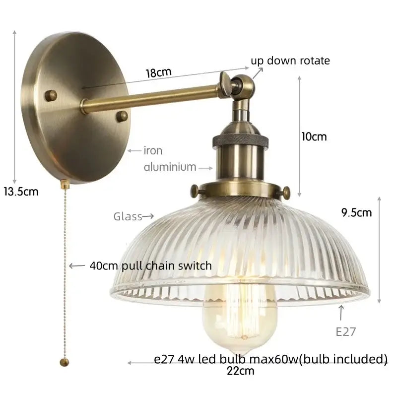 Vintage brass wall sconce with ribbed glass shade and exposed edison bulb featuring a pull chain switch