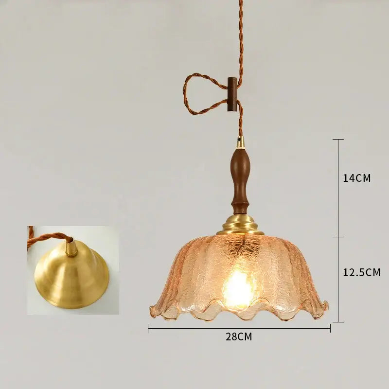 A warm amber glass led pendant lamp with textured ruffled shade and brass accents for bedroom lighting