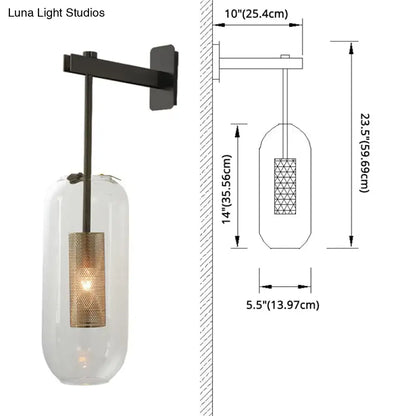 Black metal wall sconce with a brass wall lamp featuring a clear glass cylinder and gold-toned mesh glass cylinder shade