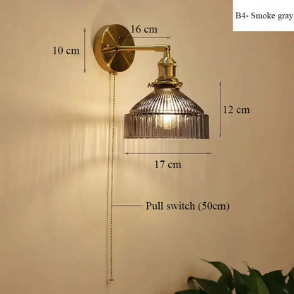 Vintage brass wall lamp with smoke gray ribbed glass shade and adjustable pull chain switch for living room use