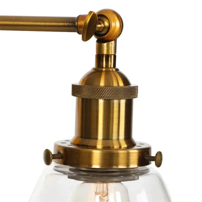 Vintage brass wall light fixture with glass dome and visible filament bulb in antique brass finish for bedroom use