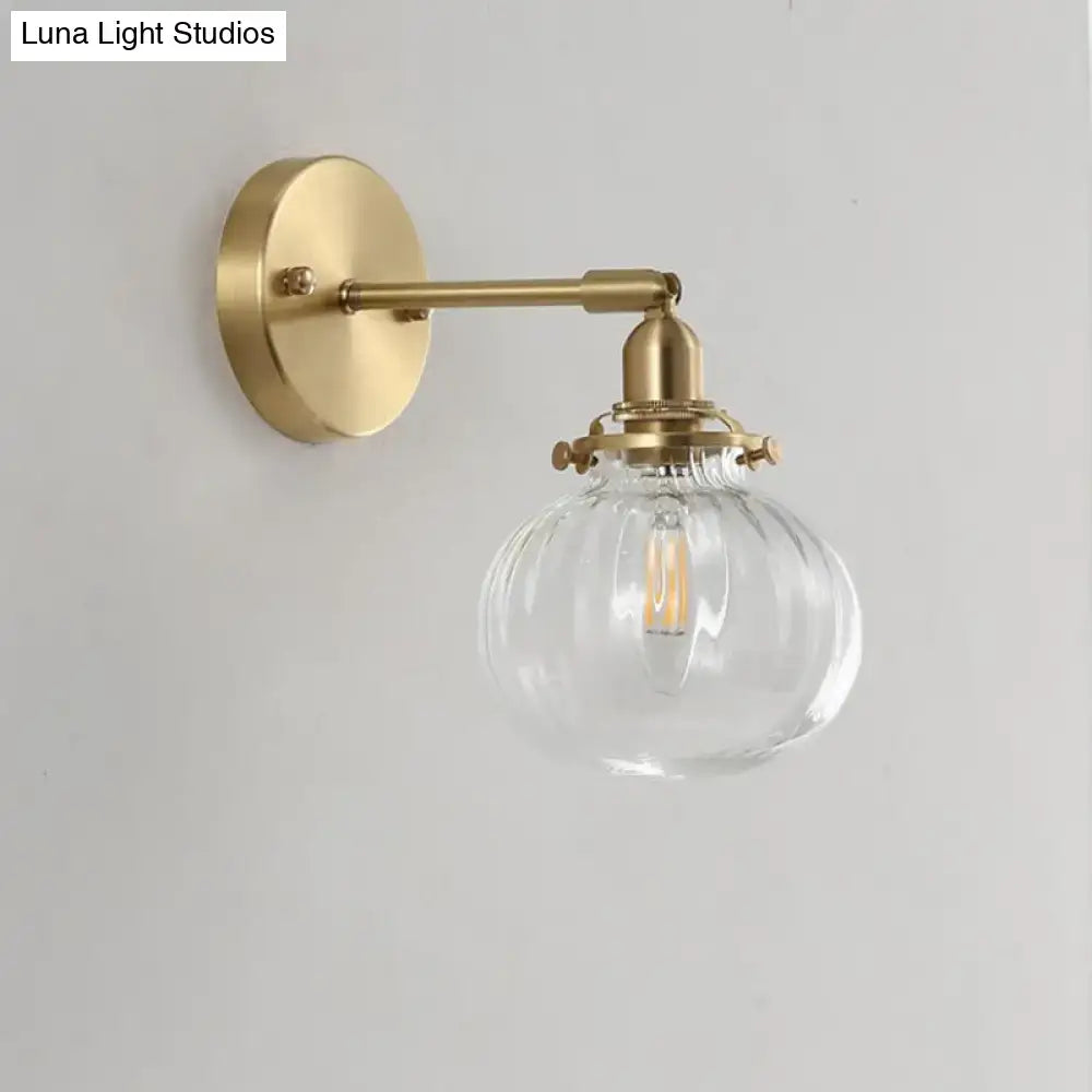 Vintage brass wall light featuring a champagne clear glass shade with ribbed texture and led bulb for bedroom use