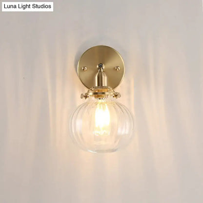 Vintage brass wall light with champagne clear glass shade and ribbed globe for elegant bedroom lighting