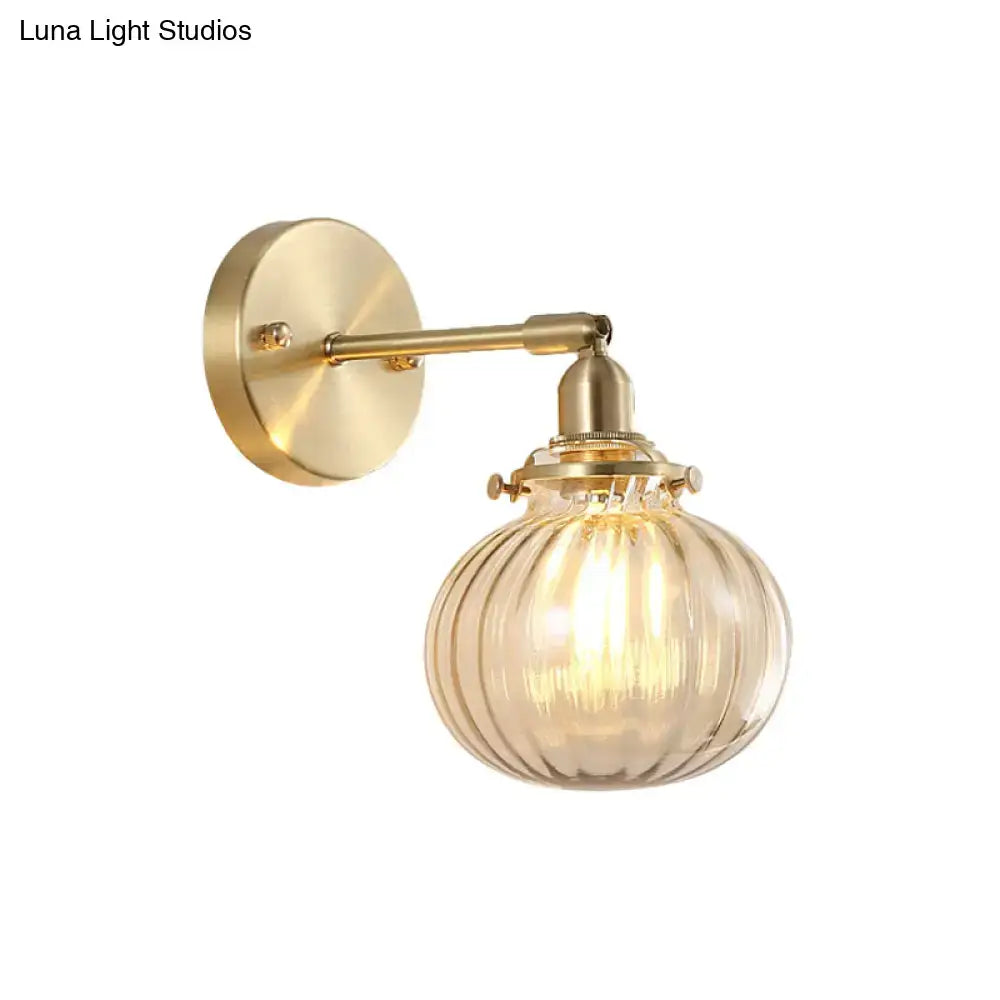 Vintage brass wall light featuring a champagne clear ribbed glass shade ideal for bedroom lighting