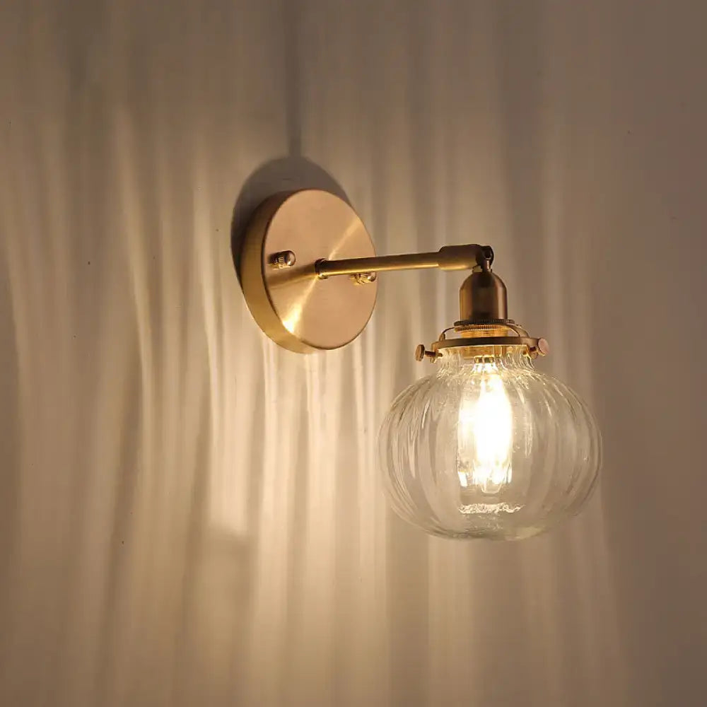Vintage brass wall light with champagne clear ribbed glass shade designed for bedroom lighting