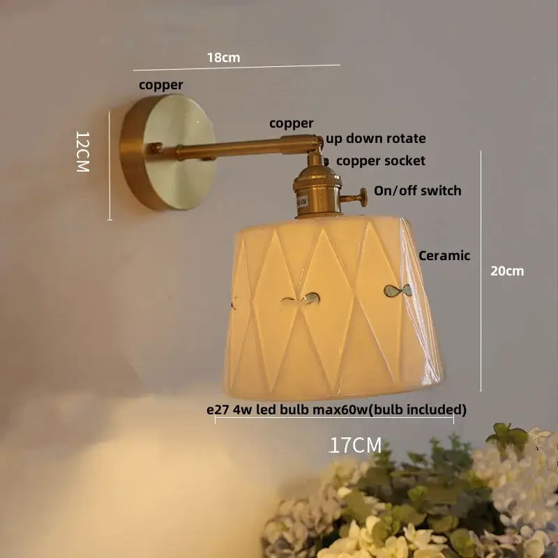 Copper-finished wall light with geometric ceramic shade featuring fish motifs and decorbites ceramic knob switch for bedroom