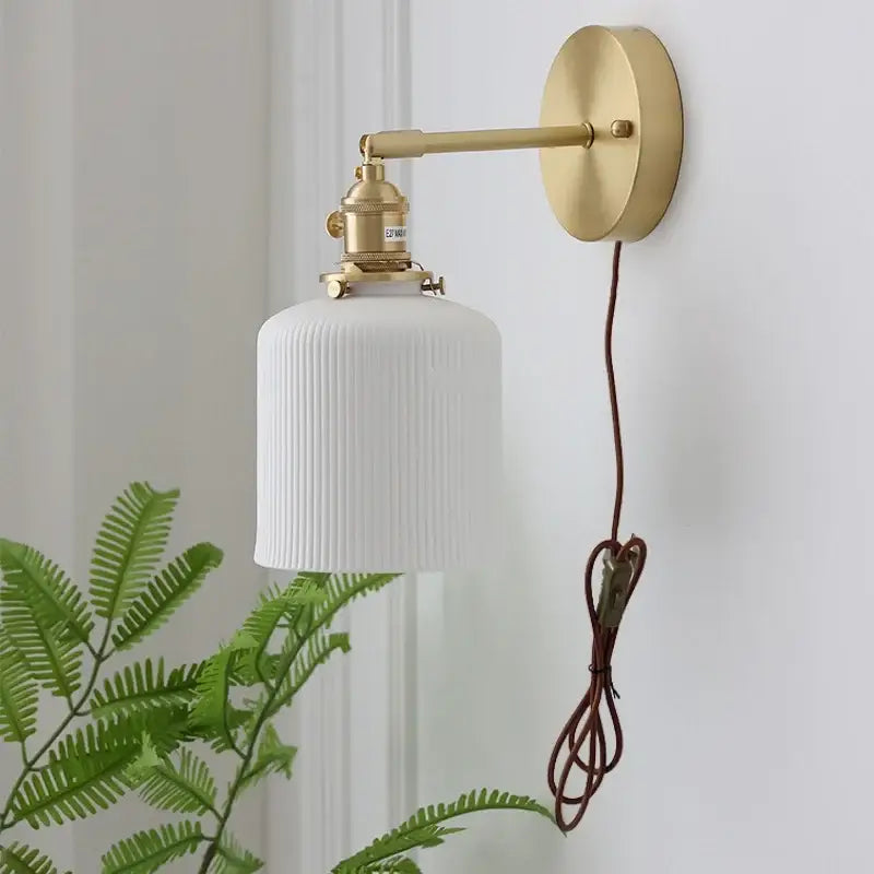 Vintage brass wall light with white ribbed glass and knob switch featuring decorbites ceramic knob for bedroom use