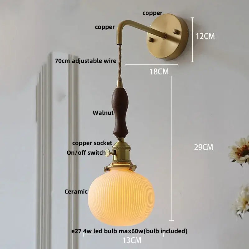 Vintage brass wall light with copper sconce, walnut handle, ribbed ceramic globe shade, knob switch, and decorbites ceramic knob