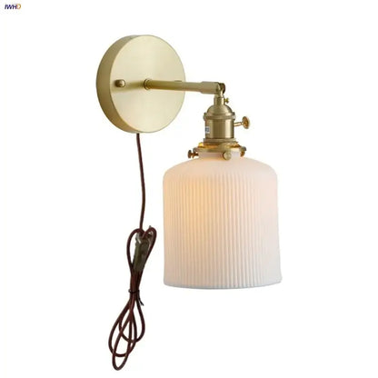 Vintage brass wall light with ribbed off-white glass shade and knob switch featuring decorbites ceramic knob design
