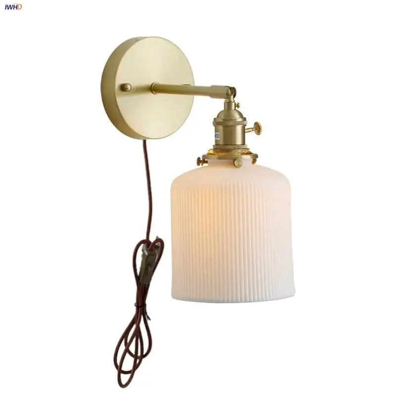 Vintage brass wall light with ribbed off-white glass shade and knob switch featuring decorbites ceramic knob design