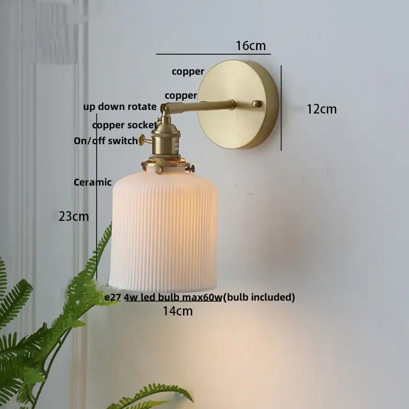 Vintage brass wall light with knob switch featuring a brass-finished copper arm and off-white ribbed decorbites ceramic knob shade