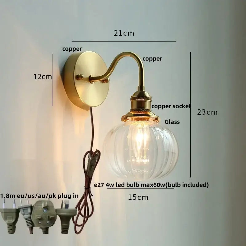 Vintage brass wall sconce with scalloped clear glass and copper finish featuring decorbites clear glass globe