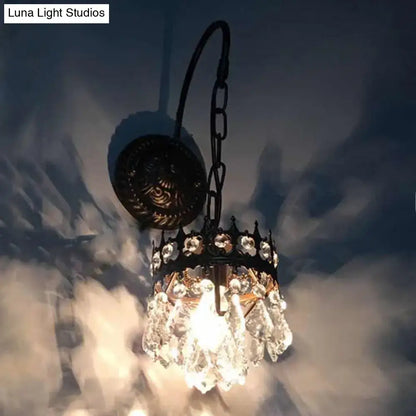 Vintage bronze crystal wall light featuring an antique-style black metal chandelier with clear crystal droplets and decorative crown top