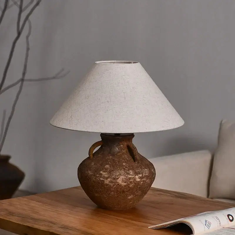 Vintage brown ceramic country table lamp with textured earthenware base and off-white linen shade for bedroom decorbites country table