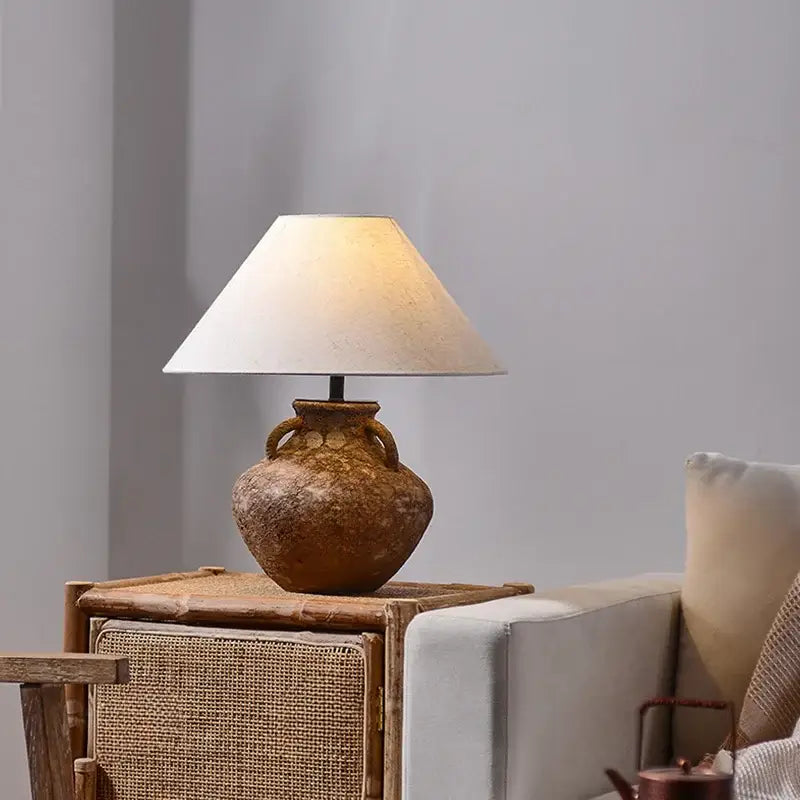 Vintage brown ceramic country table lamp with textured earthenware base and off-white fabric shade by decorbites country