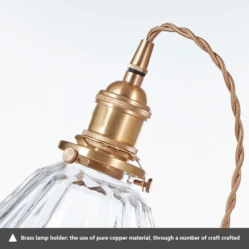 Vintage brown and polished chrome glass pendant light featuring a brass lamp holder with ridged detailing and twisted copper cord