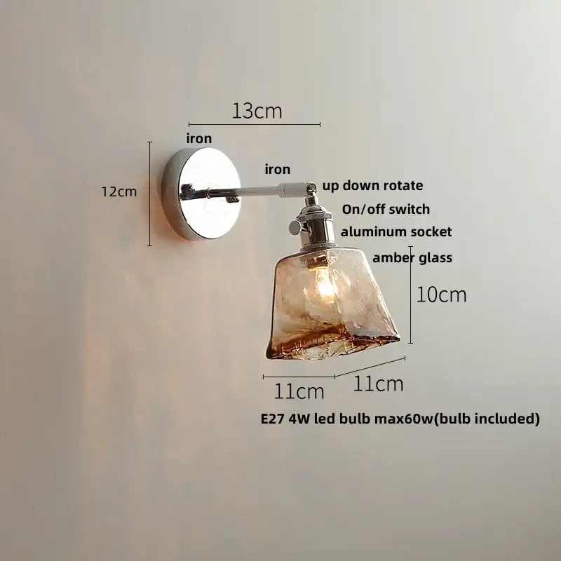 A sleek vintage brushed nickel led wall light with polished iron base amber glass shade for bedroom use