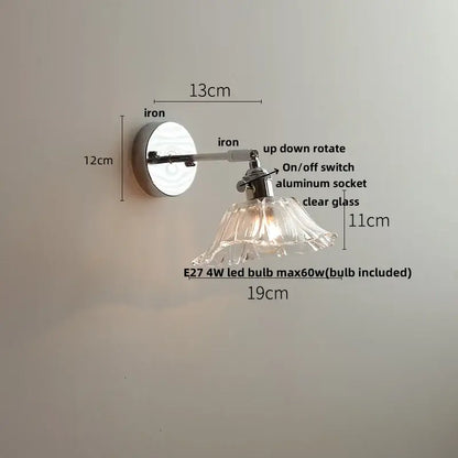 Vintage brushed nickel led wall light with a polished iron arm and clear glass petal shade for bedroom use