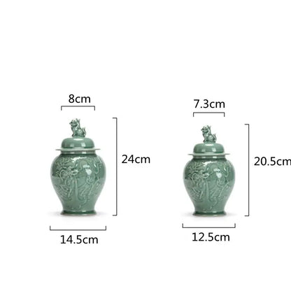 Two jade green ceramic tea caddies with intricate dragon relief and lion lid storage jars in vintage celadon porcelain
