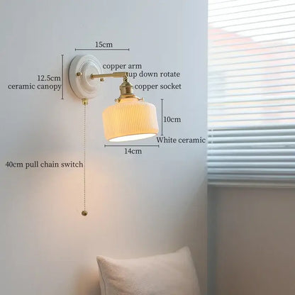 Vintage wall sconce light with white ribbed ceramic shade and brass copper arm featuring a bedroom pull chain