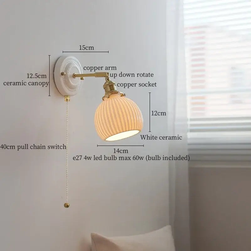 Vintage white ceramic and brass wall sconce light with ribbed glass shade and pull chain for bedroom use