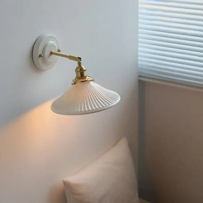 White ceramic led wall lamp with brass-finished arm and fluted shade for vintage bedroom decorbites ceramic led sconce