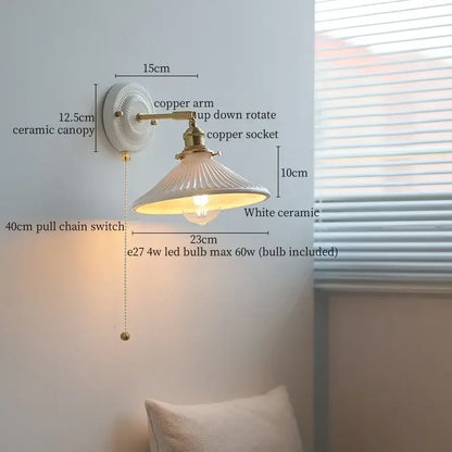 White ceramic led wall lamp with a fluted ridged shade and brass-finished copper arm by decorbites ceramic led