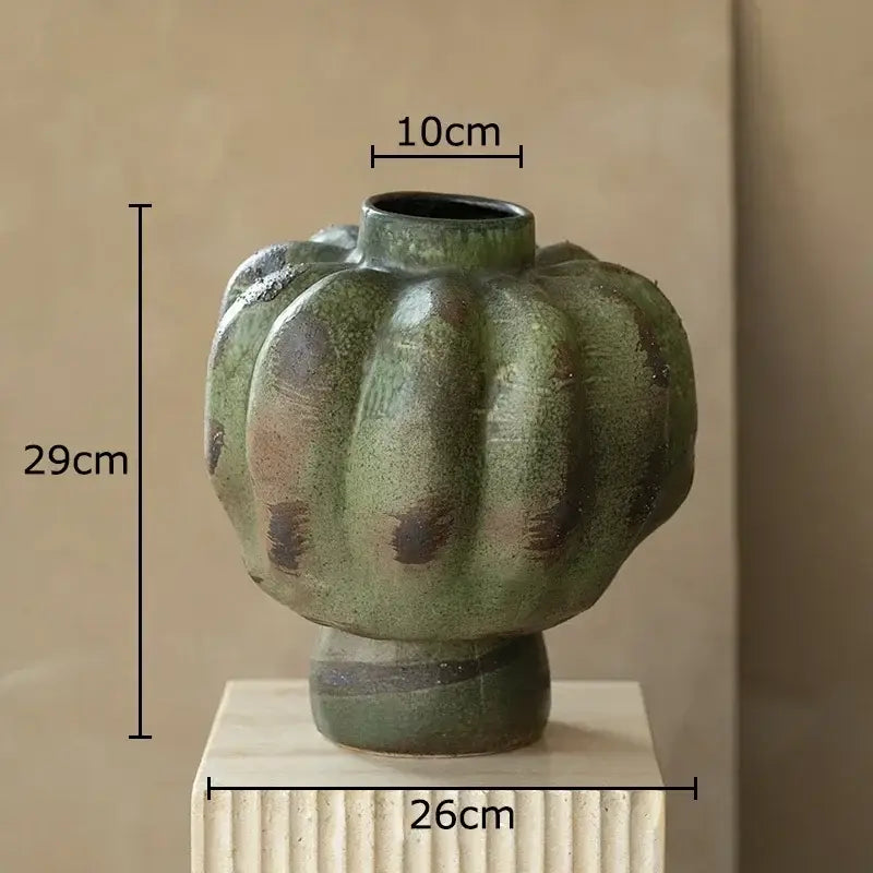A rustic green vintage ceramic vase shaped like a pumpkin with brown speckles for living room decorbites decor